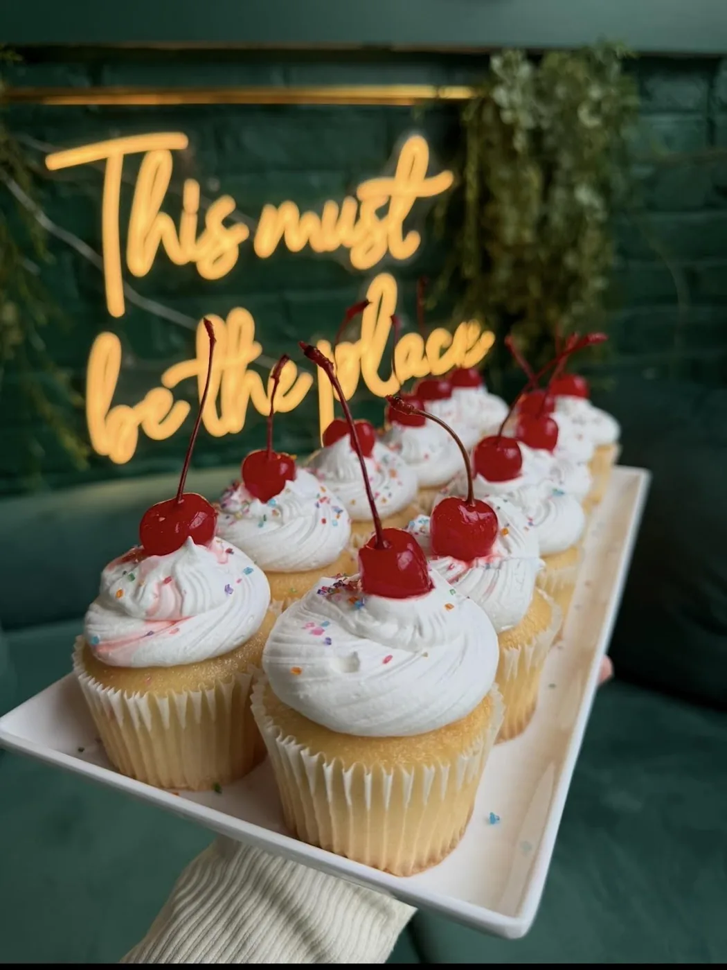 Pound cake cupcakes topped with cream and cherries